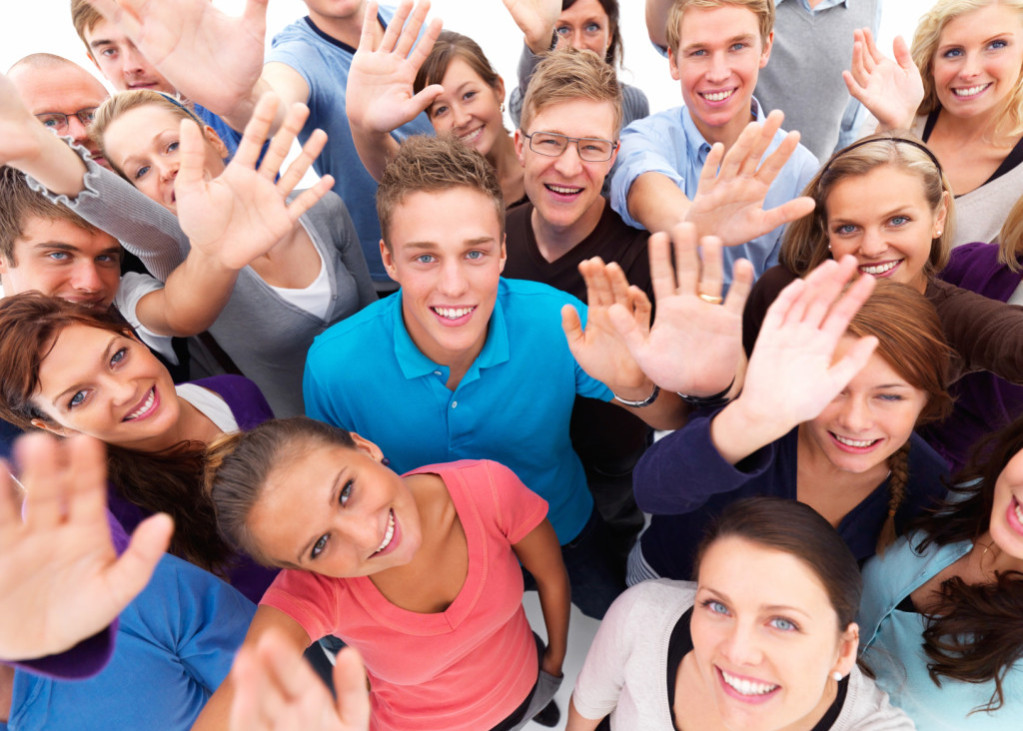 Friendly group of people waving to you
