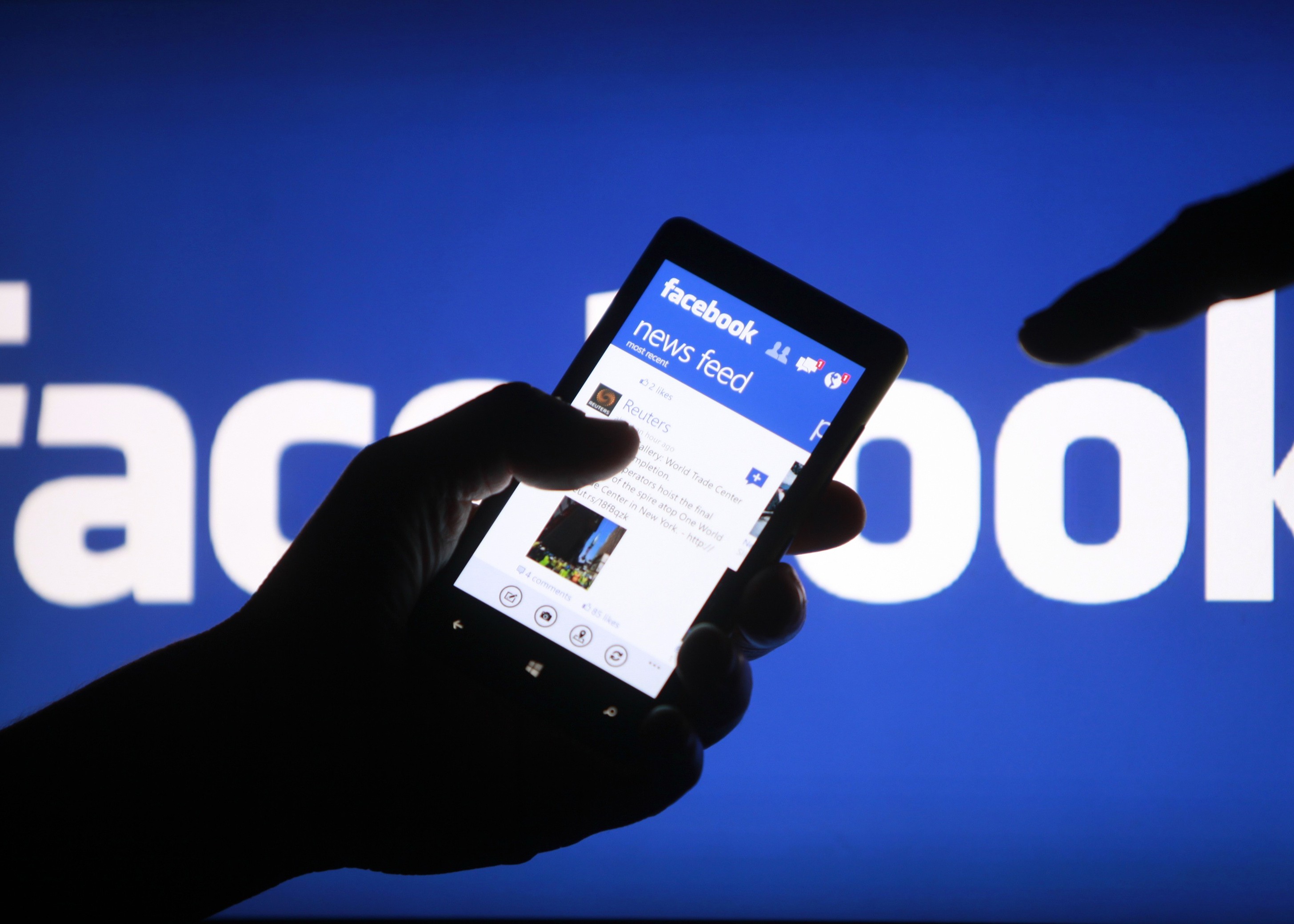 A smartphone user shows the Facebook application on his phone in Zenica, in this photo illustration